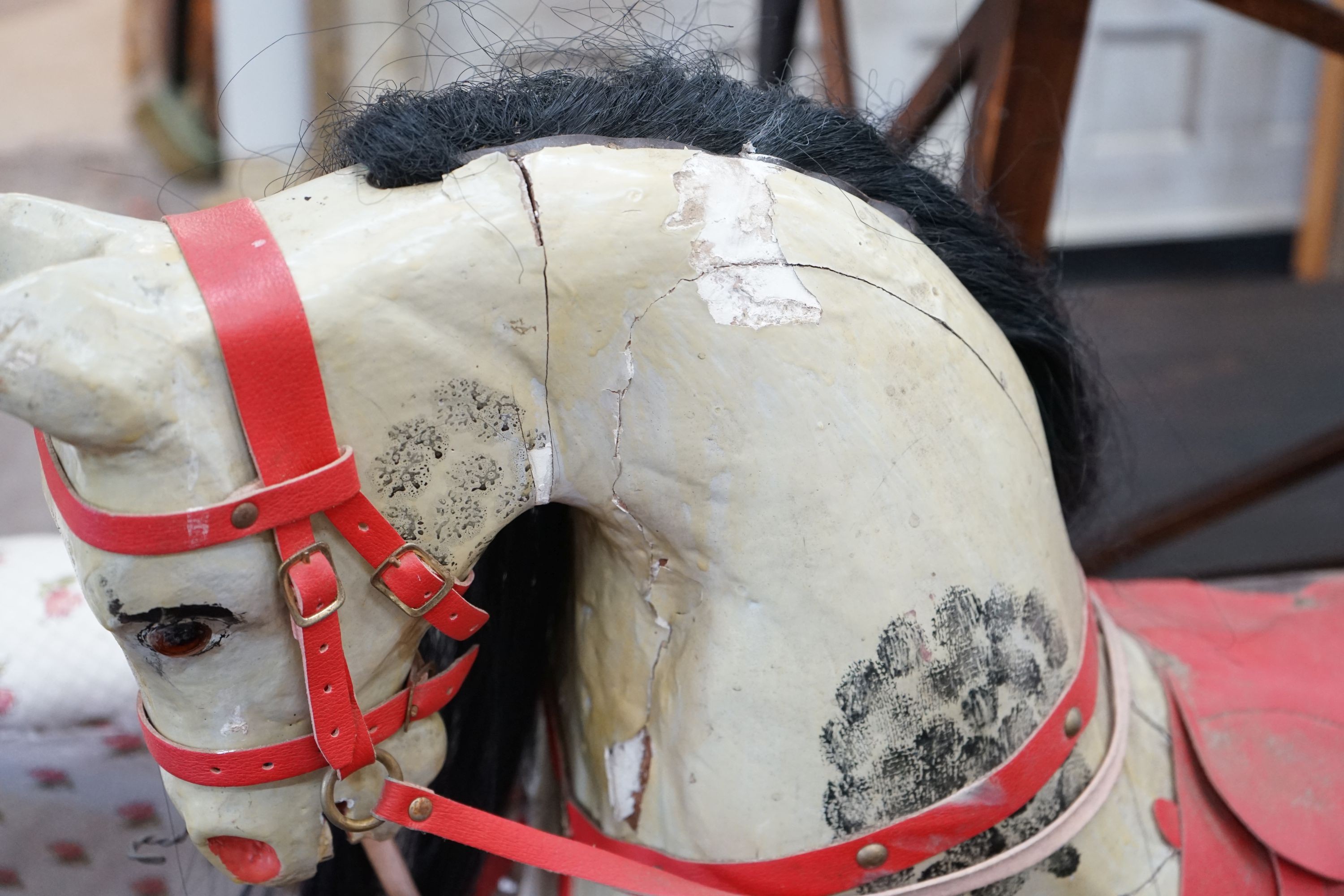 An Ayres type dappled rocking horse on pine safety frame, length 135cm